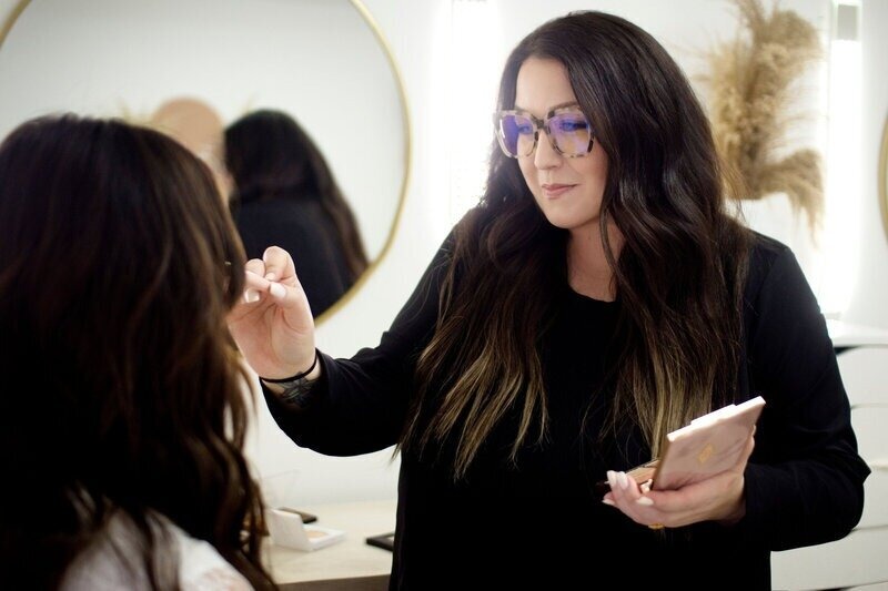 Bridal Babes Society owner Emily Blake demonstrating how to apply bridal makeup.